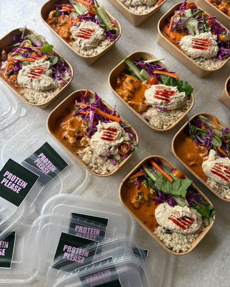 Freshly packed Protein Please boxes with branded lids, ready to go out